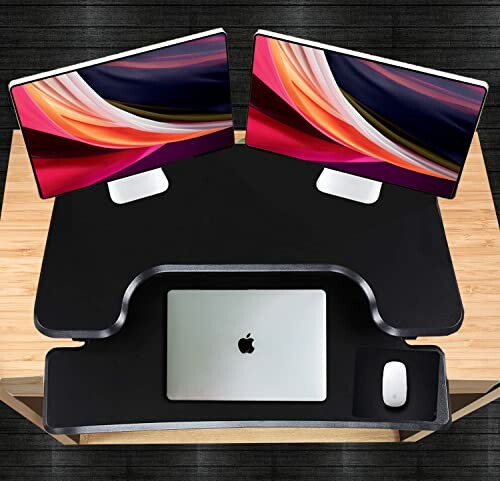 Dual monitor setup on a desk with a laptop and mouse.
