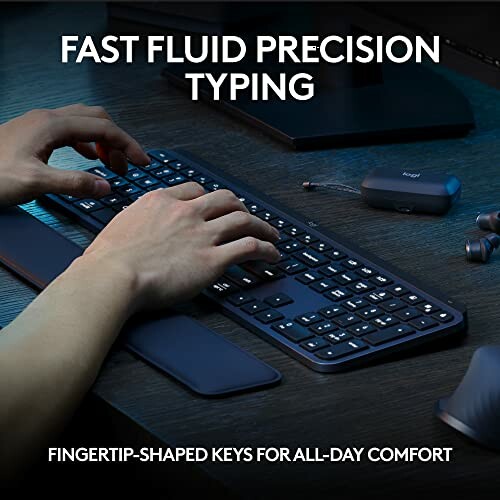 Person typing on a sleek keyboard with fingertip-shaped keys.