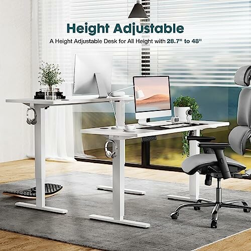 Height adjustable desk setup with monitors and office chair.
