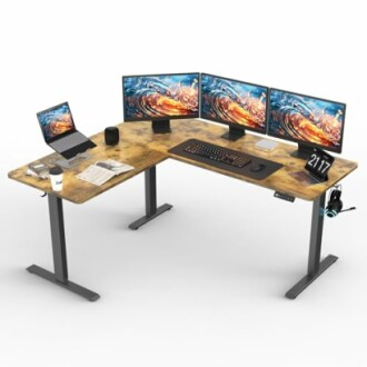 L-shaped desk with laptop, three monitors, keyboard, and accessories.