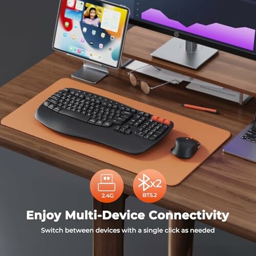 Computer desk setup with keyboard, mouse, and monitor promoting multi-device connectivity.
